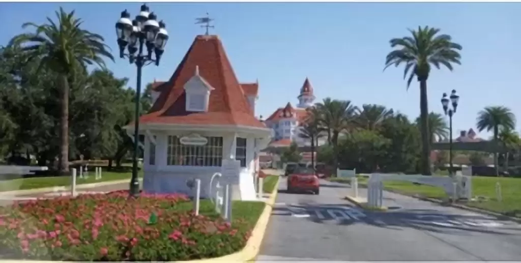 A-large-white-guard-booth-with-palm-trees-around-it