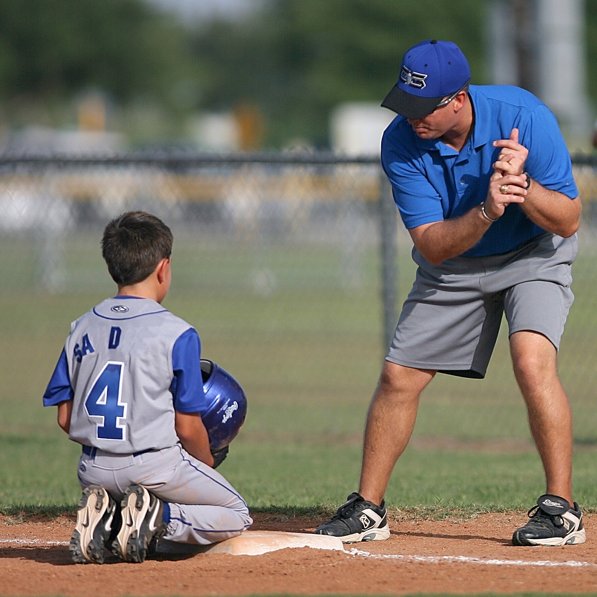 Youth sports coach working with boy