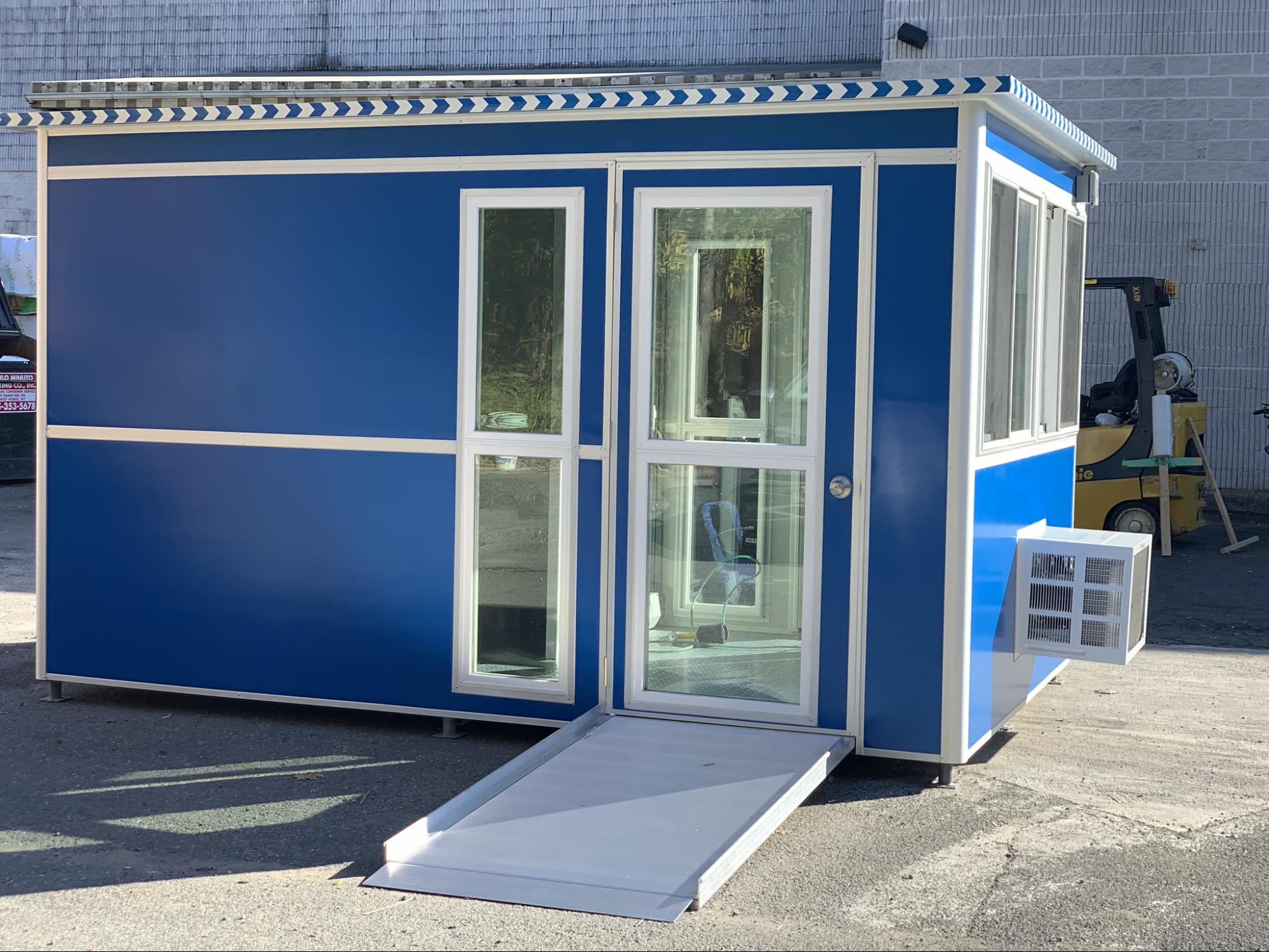 outdoor booth with glass door, a/c unit, and entrance ramp for safety and warmth in winter