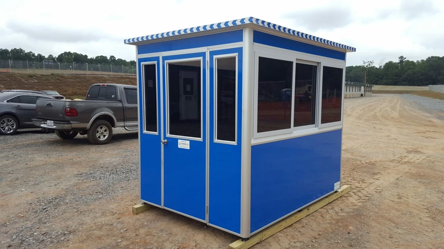 GuardianBooth portable blue guard booth placed at a construction site