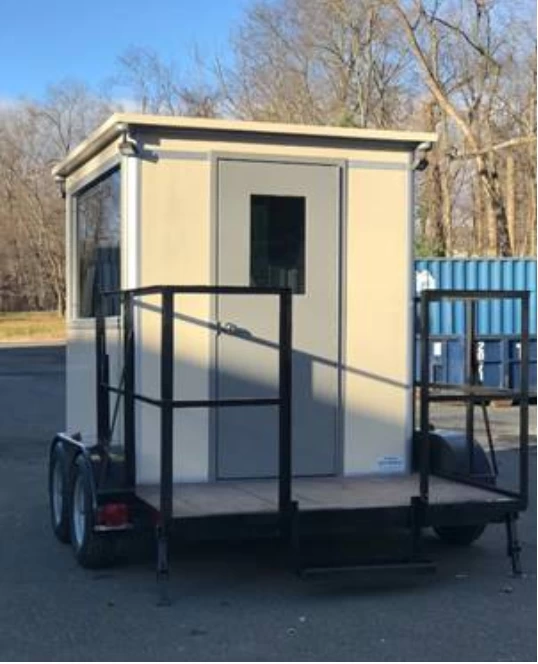 A beige guard booth on a trailer