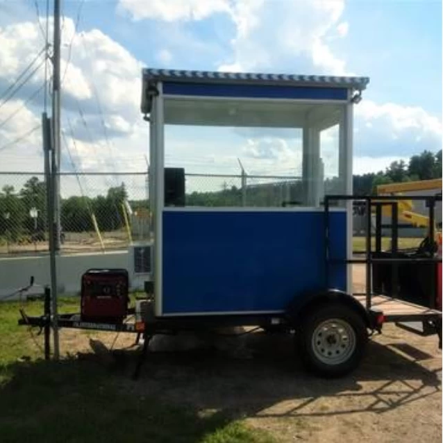 A blue trailer guard booth at a construction site