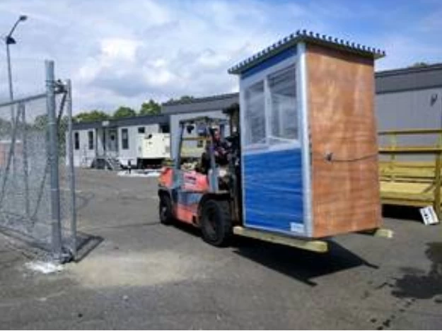 A blue guard booth on a forklift.