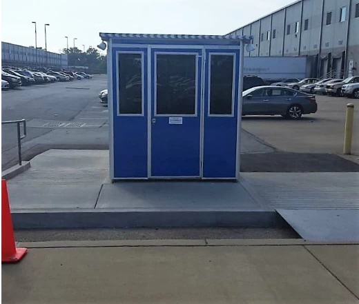 A blue guard shack in an office building parking lot