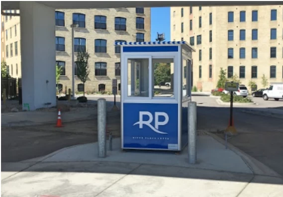 A blue parking booth in a parking lot