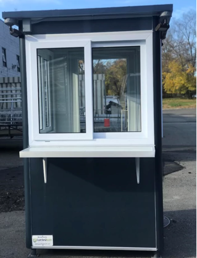 A simple dark blue booth with a customer counter