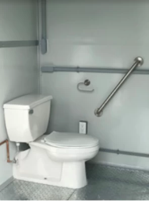 A toilet in a restroom of a modular building