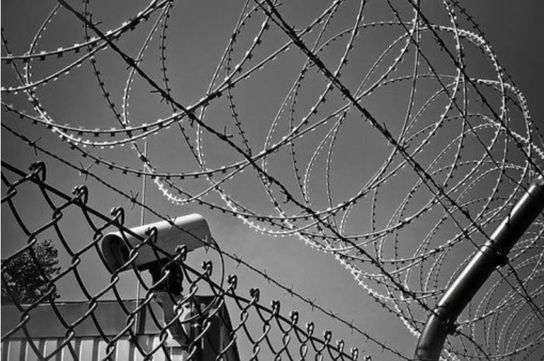 Barbed wire fence and security camera