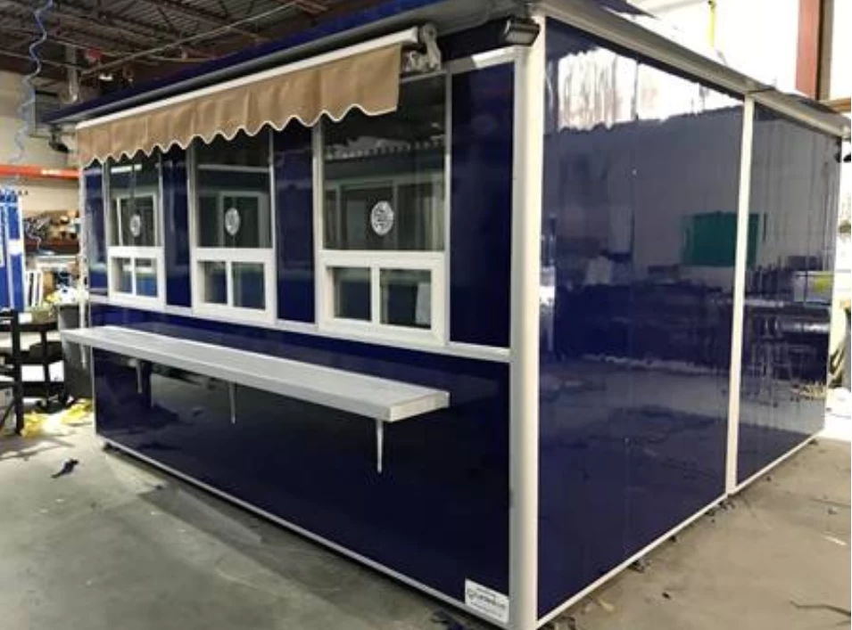 Blue ticket booth with rain awning and customer counter