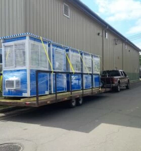 Five blue guard booths ready for delivery.