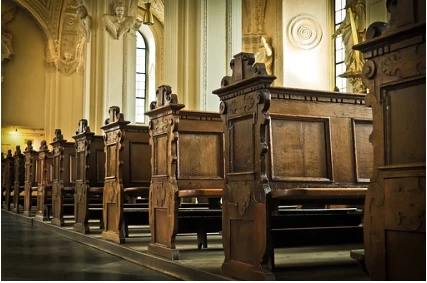 Inside an empty house of worship with pews