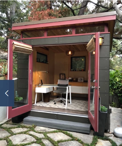 She shack with pink trim and open French doors