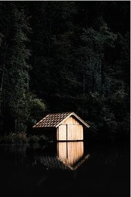 Small cabin on a dark lake