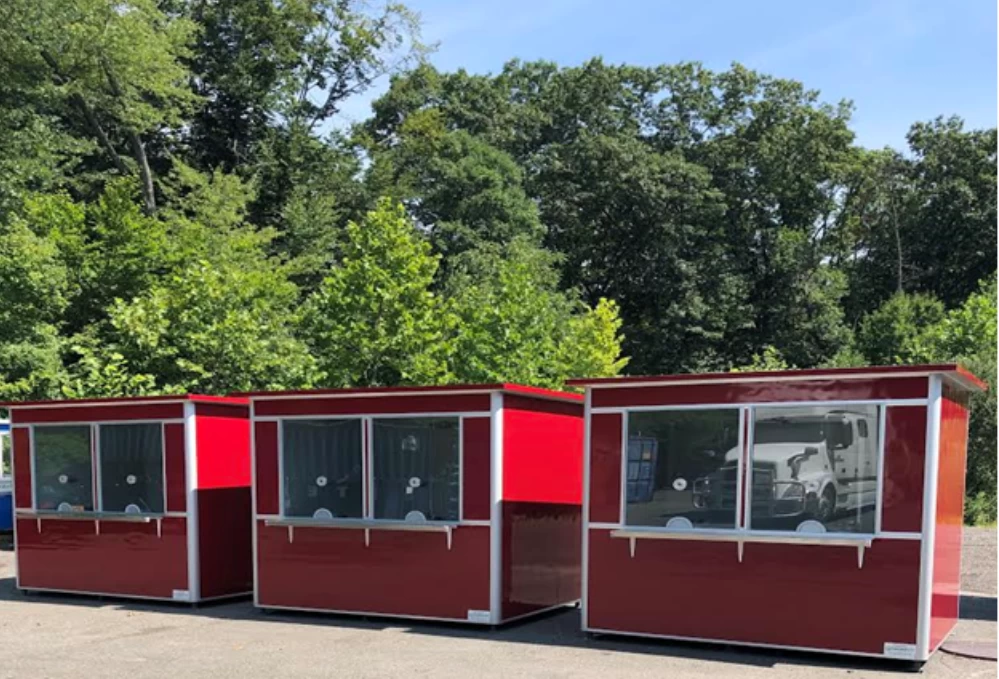 Three large, red ticket booths lined up in a row