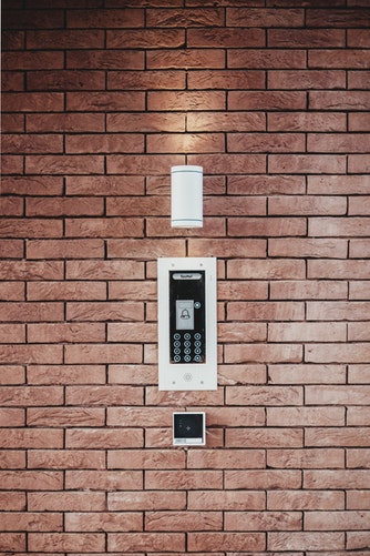 An emergency intercom and light on a brick wall of a building