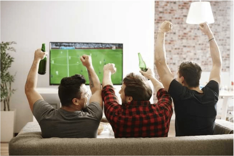 men cheering in a man cave shed