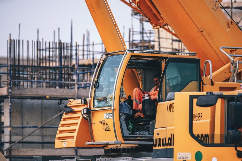 Construction worker sitting in an excavator - Guardian Booth